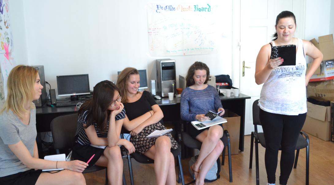 Teenage volunteers work as a group to find the best stories for the magazine Journalism volunteers discuss their story ideas as part of their Journalism Project for teenagers